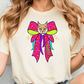 A woman wearing a white t-shirt with a colorful graphic design of a cat's face on it.