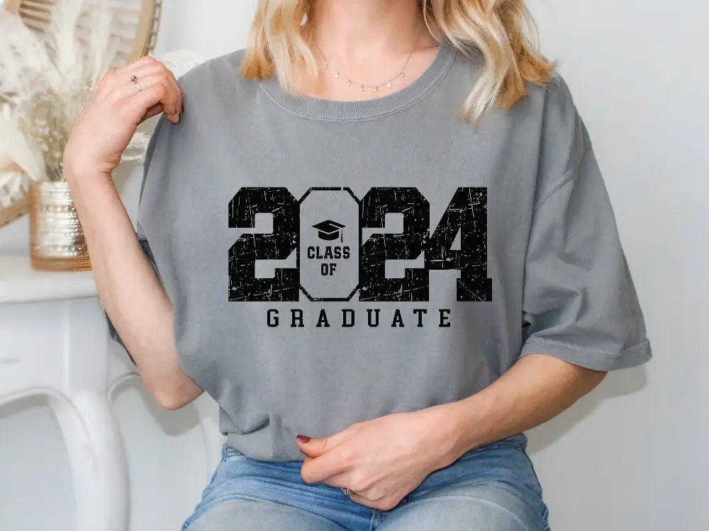 a woman wearing a gray graduation t - shirt