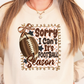 A person wearing a white sweatshirt with a graphic design featuring a football and the text "Sorry I Can't It's Football Season" printed on it.