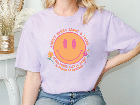 a woman wearing a t - shirt with a smiley face on it