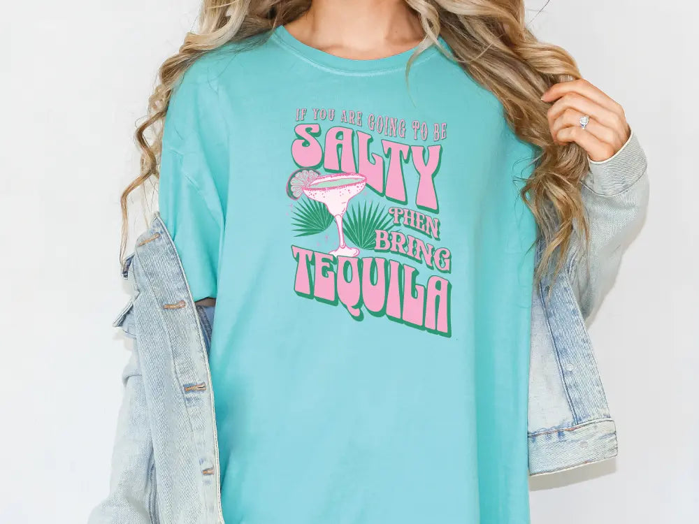 a woman wearing a t - shirt that says salty green margarita