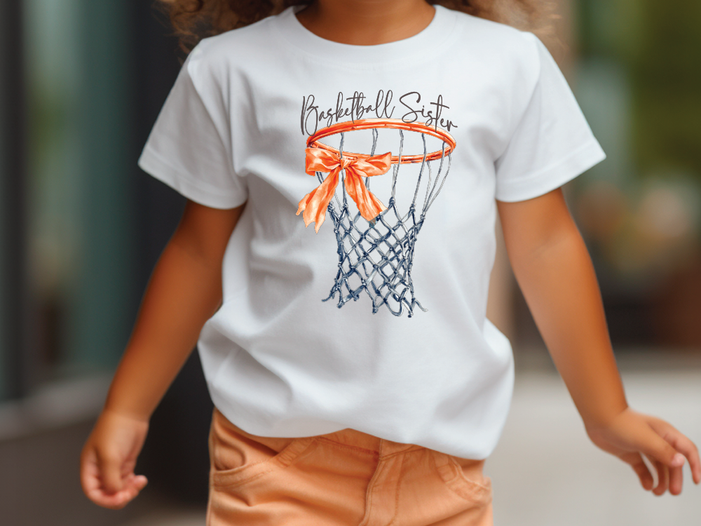 a little girl wearing a t - shirt with a basketball hoop on it