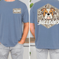 a man wearing a blue t-shirt with a graphic of a bulldog and the word "Bulldogs" printed on it. The t-shirt has a camouflage pattern on the front and a hexagon with the bulldog's face on the back.