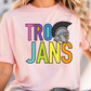 A woman wearing a pink t-shirt with the text "TRO JANS" printed on it.