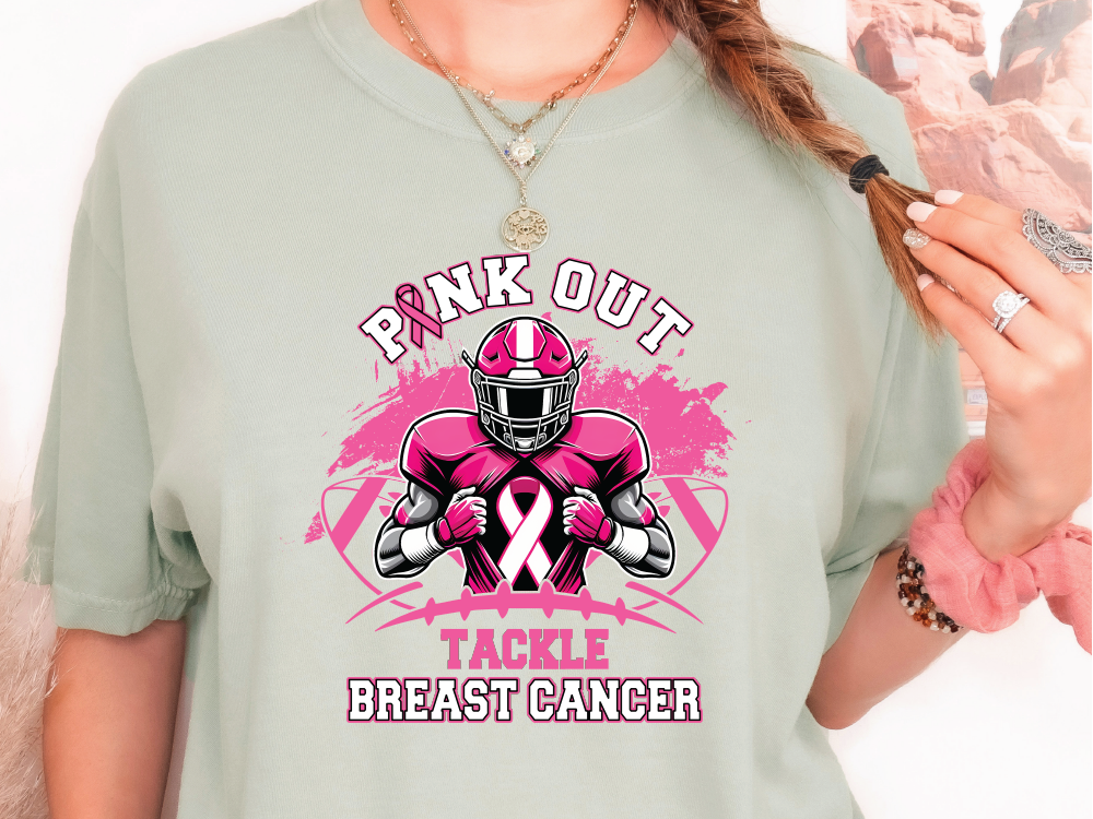 a woman wearing a pink out tackle breast cancer t - shirt