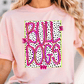 A woman wearing a pink t-shirt with the text "Bull Dogs" printed on it.