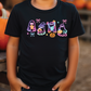 a young boy standing next to a pile of pumpkins