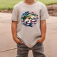 a young boy wearing a t - shirt with a fish on it