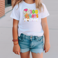 a little girl wearing a white shirt and denim shorts