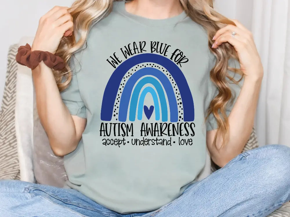 a woman wearing a t - shirt that says autism awareness