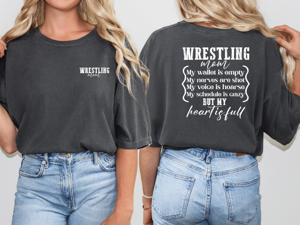 two women wearing black t-shirts with white text on the back.