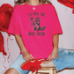 a girl sitting on a stool with red balloons behind her