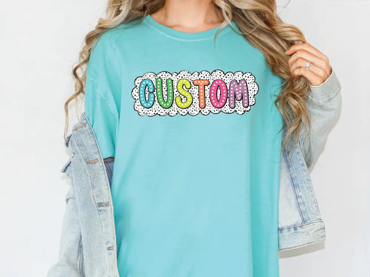 a woman wearing a turquoise shirt with the word custom printed on it