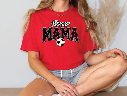 a woman wearing a red shirt with a soccer ball on it