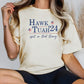 a woman wearing a t - shirt that says hawk tuah