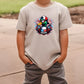 a young boy wearing a t - shirt with a cartoon character on it