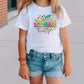 a little girl wearing a white shirt and shorts