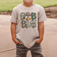 A child wearing a t-shirt with a graphic design featuring the text "GOBBIG" and a turkey-like character.