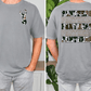 a man wearing a gray t-shirt with a graphic design on the front and back.