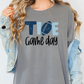 a woman wearing a t - shirt that says toe game day