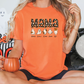 a woman sitting on a bed holding a pumpkin