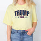 a woman wearing a yellow shirt with the word trump printed on it