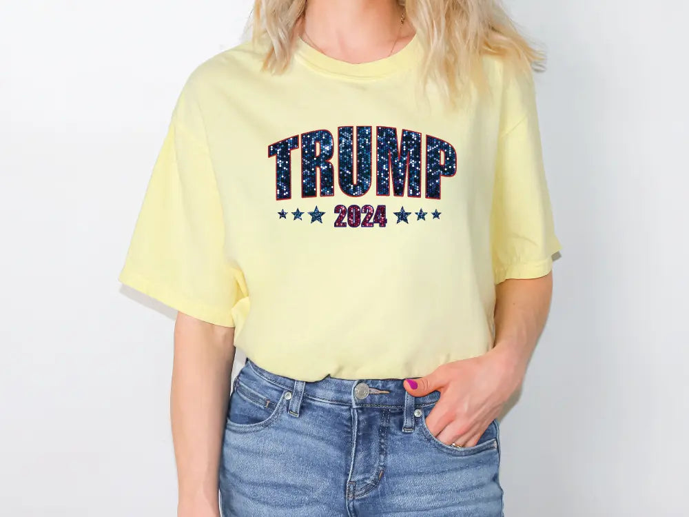 a woman wearing a yellow shirt with the word trump printed on it