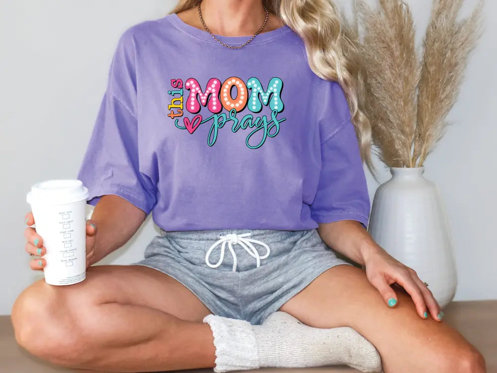 a woman sitting on a table holding a coffee cup