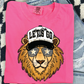 A pink t-shirt with a cartoon lion wearing sunglasses and a baseball cap with the text "LET'S GO" printed on it.