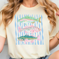 A woman wearing a white t-shirt with a graphic design of three colorful fish.