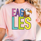 A woman wearing a pink t-shirt with the word "EAGLES" printed on it, along with an illustration of an eagle.