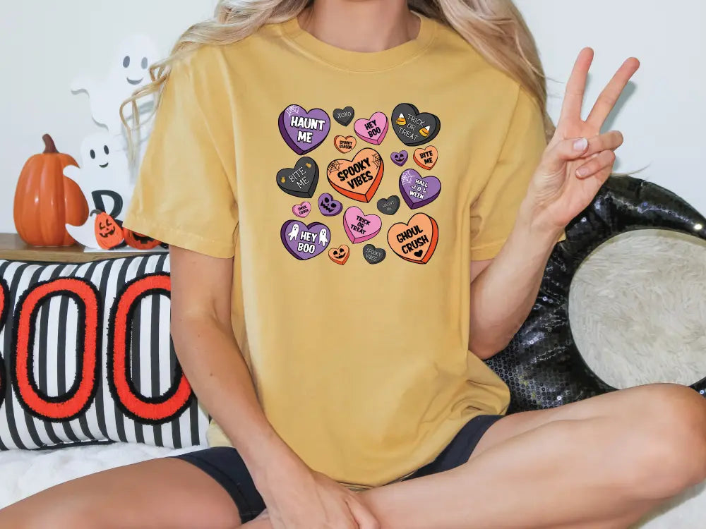 a woman sitting on a bed holding a peace sign