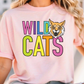 A woman wearing a pink t-shirt with the text "WILD CATS" printed on it.