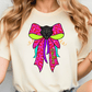 A woman wearing a white t-shirt with a colorful graphic design featuring a black panther's face and a pink bow.
