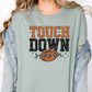 a woman wearing a t - shirt with the words touch down on it