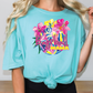 a woman with blonde hair wearing a turquoise shirt