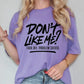 a woman wearing a purple shirt that says don't like me