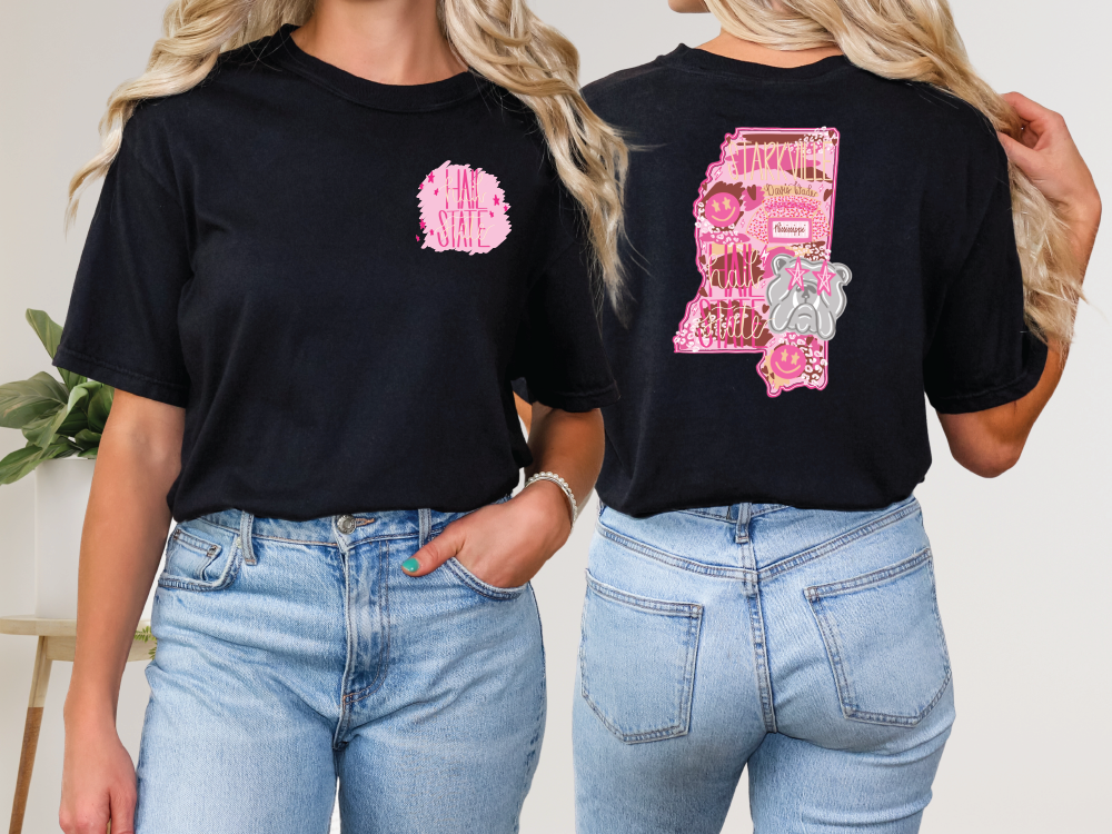 two women wearing black shirts with pink letters on them