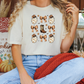 a woman sitting on a couch wearing a t - shirt with dogs on it