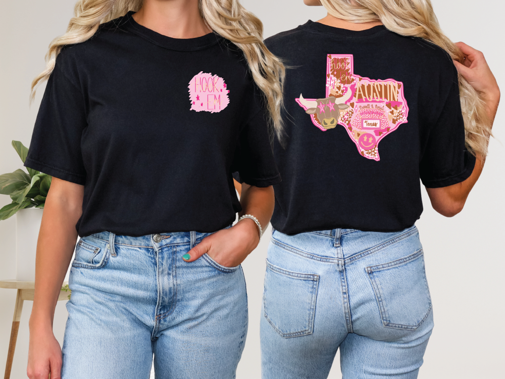 two women wearing black shirts with pink and gold designs