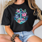 a woman sitting on a chair wearing a t - shirt with an anchor and flowers