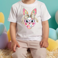 a little boy sitting in front of a bunch of balloons