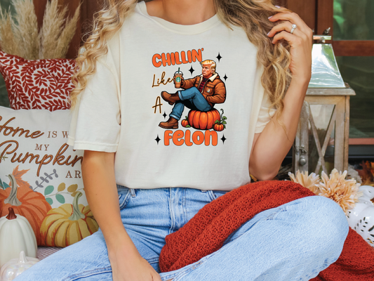 a woman sitting on a couch wearing a t - shirt that says chillin '