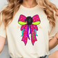 A woman wearing a white t-shirt with a colorful bow graphic and the word "Rainbow" printed on it.