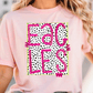 A woman wearing a pink t-shirt with a graphic design featuring the word "EAGLES" in pink and black, with a dotted pattern.