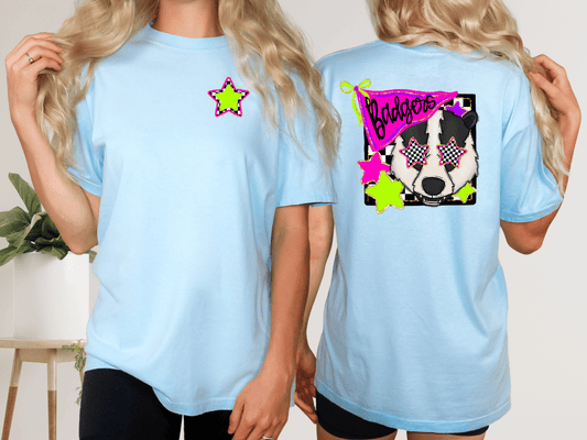 two women wearing light blue t-shirts with a graphic design on the back. The design features a dog's face wearing sunglasses and a star.
