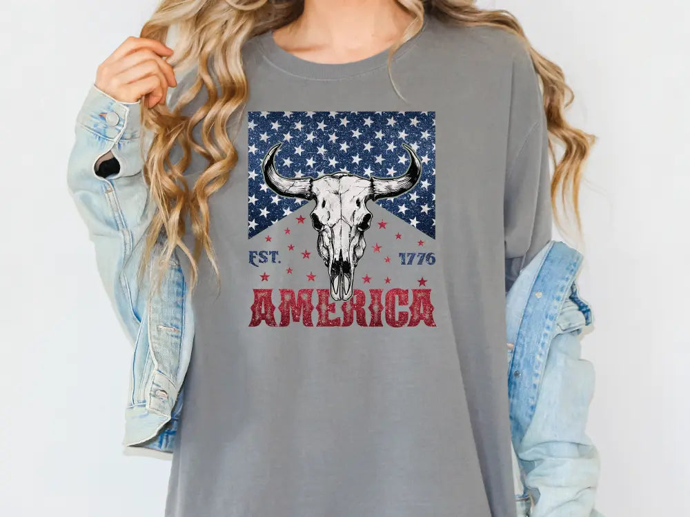 a woman wearing a long sleeve shirt with an american flag design