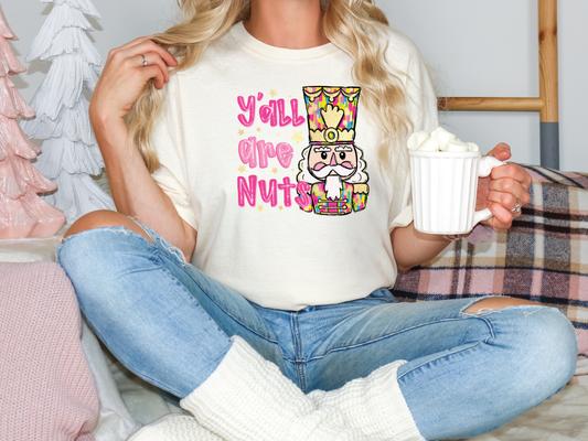 a woman sitting on a bed holding a cup of coffee