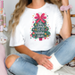 a woman sitting on a bed wearing a t - shirt with a christmas tree on