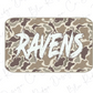 A camouflage-patterned rectangular object with the word "RAVENS" written in a stylized, graffiti-like font.